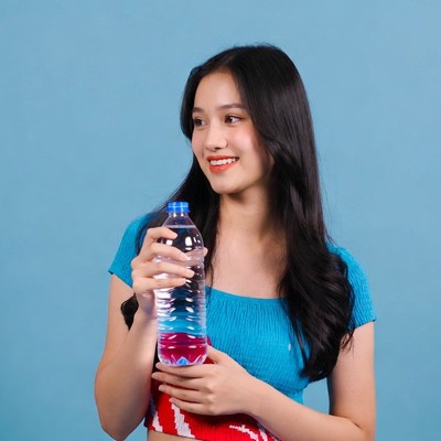 Asian woman holding water bottle