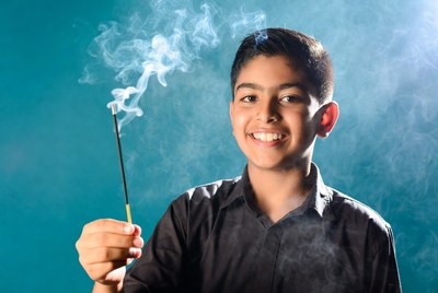 Indian boy holding incense stick