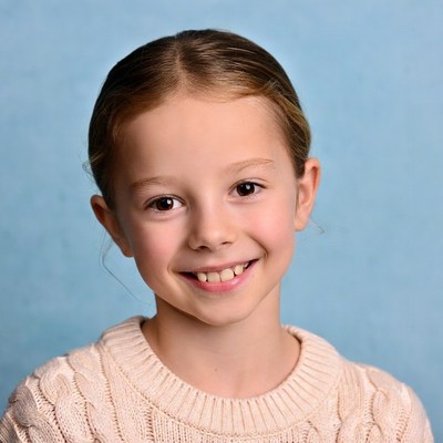 Smiling girl in white sweater