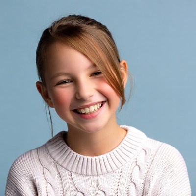 Smiling girl in white sweater