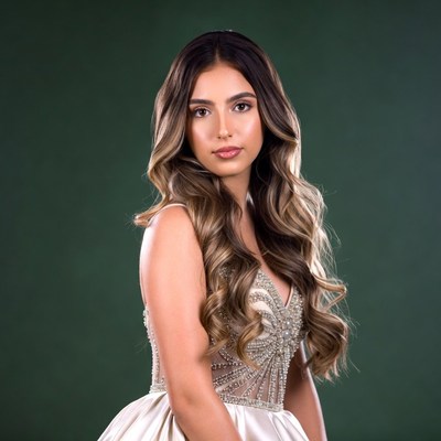 Woman in beaded gown on green background