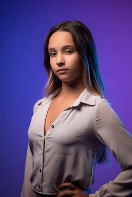 Teen girl in white blouse on purple background
