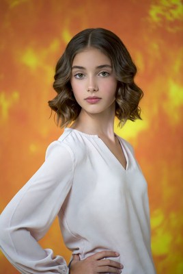Teen girl posing on orange background