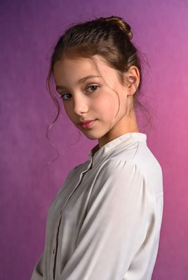 Girl with bun hairstyle on purple background