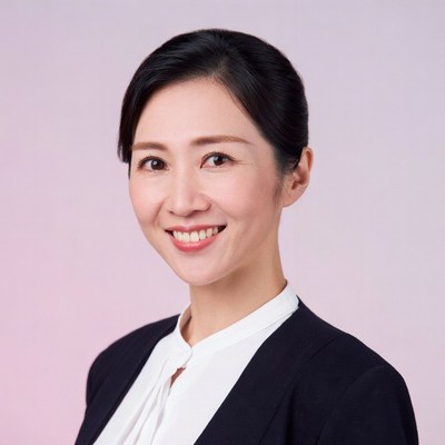 Asian woman in black blazer smiling