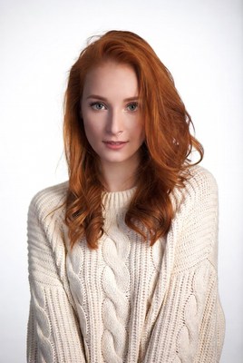 Redhead woman in white sweater