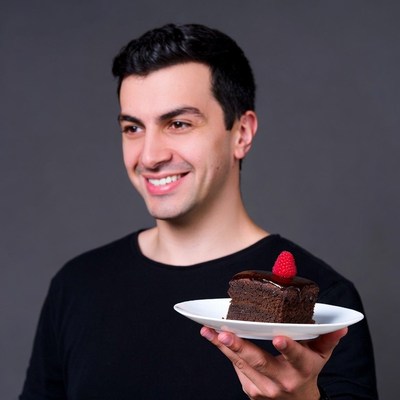 Man holding chocolate cake raspberry