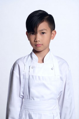 Asian boy in white chef uniform