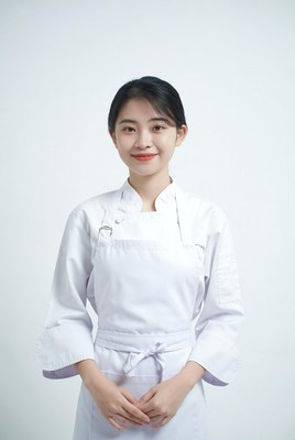 Asian woman in white chef uniform