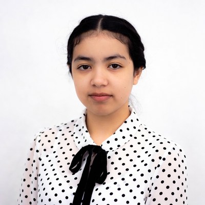 Asian girl in polka dot blouse