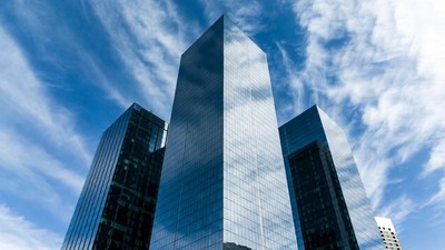 Three Modern Skyscrapers Against Blue Sky
