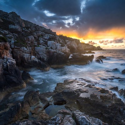 Rocky Coastline at Sunset with Waves