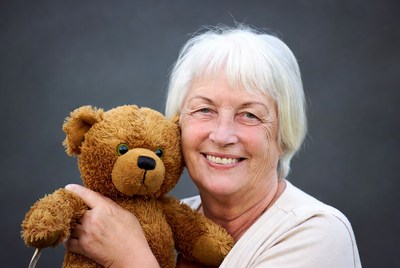 Elderly woman hugging teddy bear