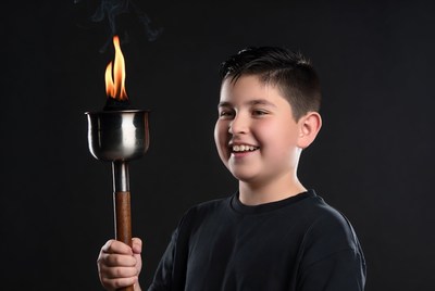 Boy holding lit torch