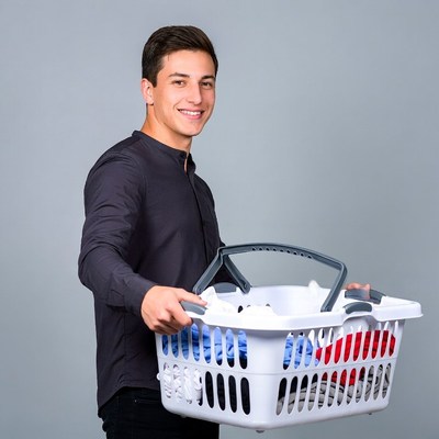 Young man holding laundry basket
