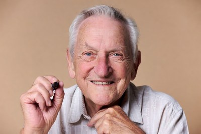 Elderly man holding marker