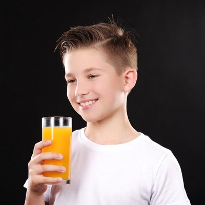 Boy drinking orange juice