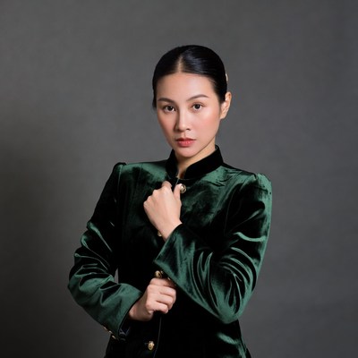 Asian woman in green velvet cheongsam