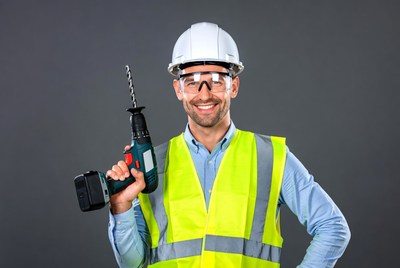 Man holding drill in hard hat
