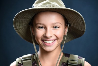Smiling girl in khaki hat and vest