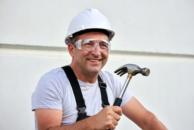 Man holding hammer in hard hat