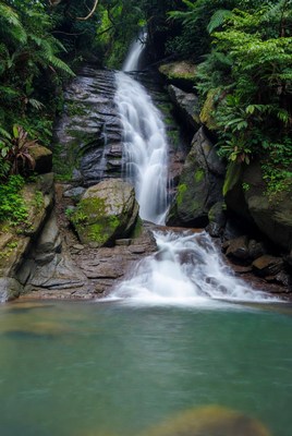 Waterfall cascading into emerald pool