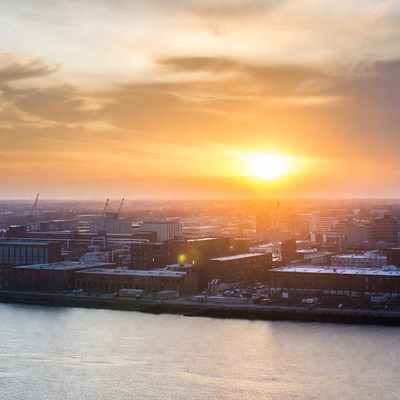 Sunset over city skyline and river