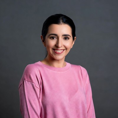 Smiling Middle Eastern woman in pink sweater
