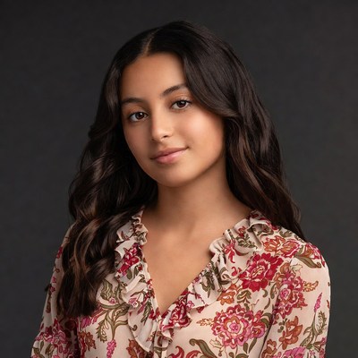 Young Latina girl in floral blouse