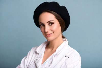 Woman wearing black beret and white shirt