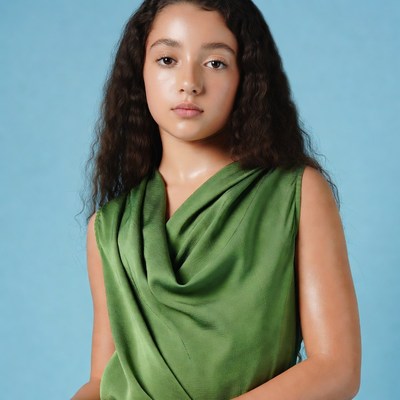 Young girl in green draped dress