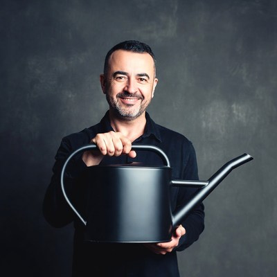 Man holding black watering can