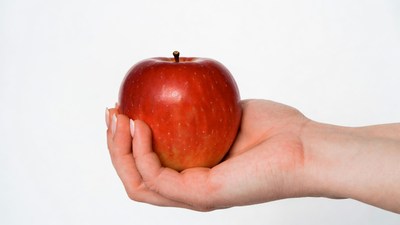 Woman holding red apple