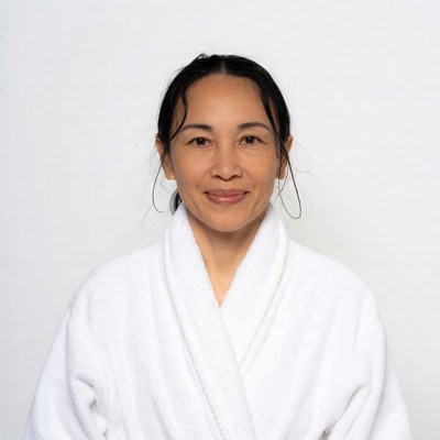Asian woman in white bathrobe