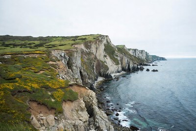 Cliff Coastline with Green Hills and Ocean