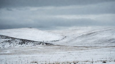 Snowy Hills Under Gray Clouds