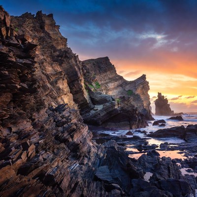 Dramatic Sunset Over Rugged Coastal Cliffs