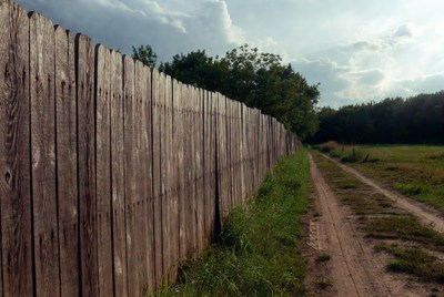 Wooden fence along dirt path