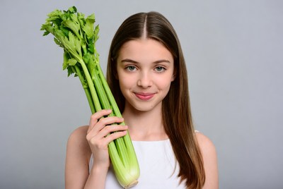Girl holding fresh celery