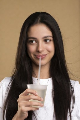 Woman drinking from straw cup