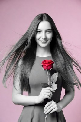 Young woman holding red rose