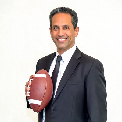 Man in suit holding football