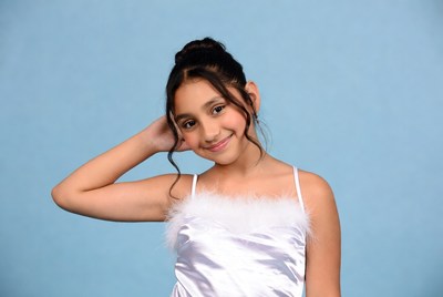 Smiling Latina girl hand on head