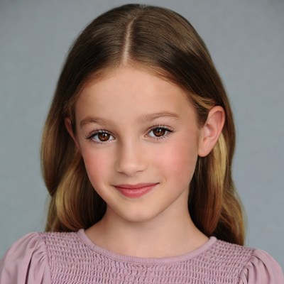 Smiling young girl in pink dress