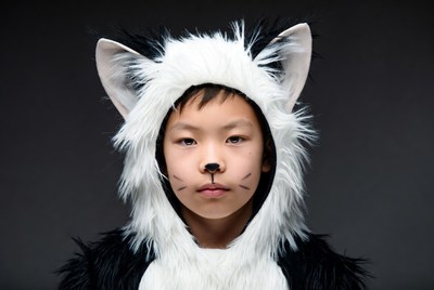 Asian boy in white cat costume