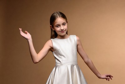 Young girl waving in silver dress
