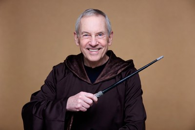 Elderly man in wizard robe holding wand