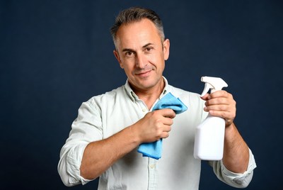 Man holding cleaning spray bottle and cloth