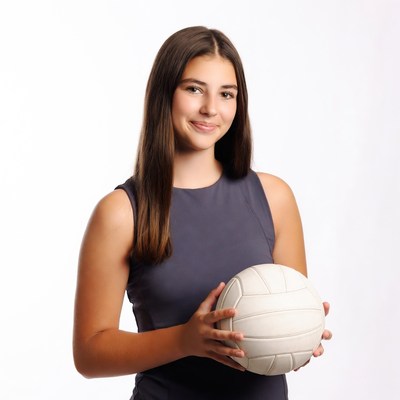 Teen girl holding volleyball
