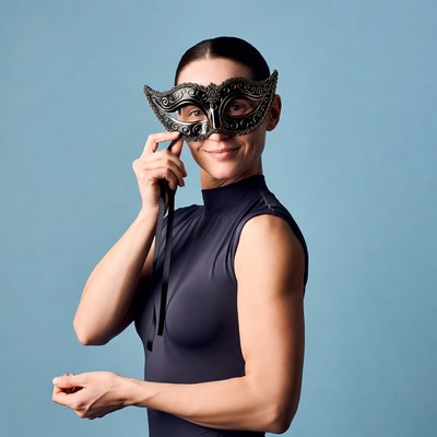Woman holding ornate masquerade mask
